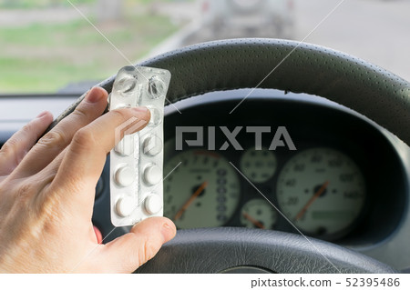 driver hand holds a pills 52395486