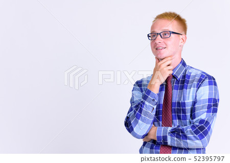 Happy young blonde businessman with eyeglasses thinking Happy young blonde businessman with eyeglasses thinking 52395797