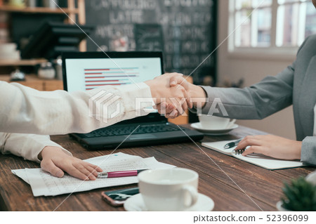 business partners shaking hands in cafe business partners shaking hands in cafe 52396099