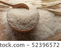 Jasmine rice in a wooden bowl and wooden spoon  52396572