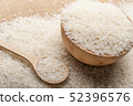 Jasmine rice in a wooden bowl and wooden spoon 52396576