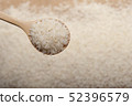 Close up view of rice in a wooden spoon 52396579