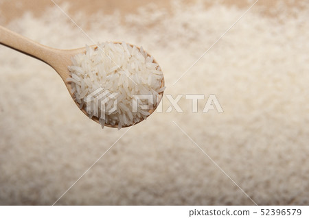 Close up view of rice in a wooden spoon 52396579