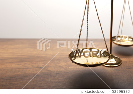 Gold brass balance scale on wooden desk 52396583