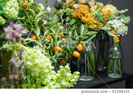 Flower shop concept. Glass vases with different colors on the shelves of the refrigerator showcases Flower shop concept. Glass vases with different colors on the shelves of the refrigerator showcases 52399141