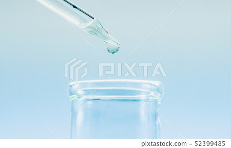 Pipettes take samples to a test tube containing ch 52399485