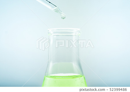 Pipettes take samples to a test tube containing ch 52399486
