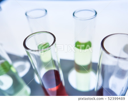 Pipettes take samples to a test tube containing ch Pipettes take samples to a test tube containing ch 52399489