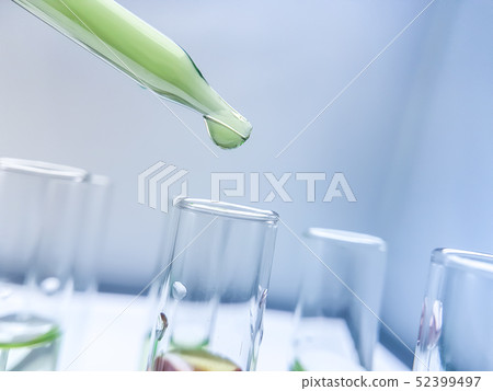 Pipettes take samples to a test tube containing ch 52399497