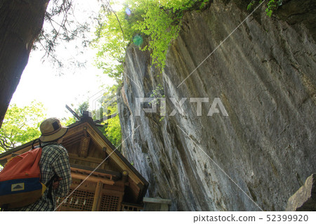 Foreign tourists find Shirakaba Shrine and a huge rock on the Okutama old road in Okutama, Tokyo (May) 52399920