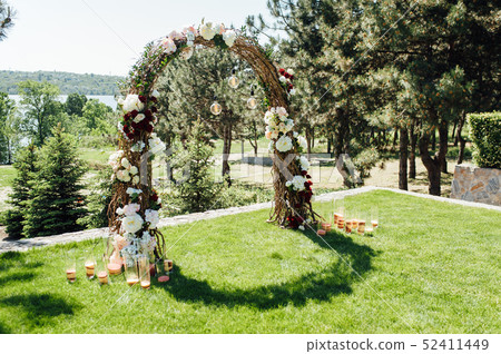 beautiful arch for the wedding ceremony in the park with white chairs for guests beautiful arch for the wedding ceremony in the park with white chairs for guests 52411449