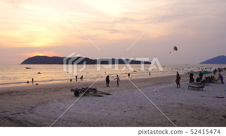 KEDAH, LANGKAWI, MALAYSIA - APR 08th, 2015: Tourists having romantic moment during sunset at Cenang KEDAH, LANGKAWI, MALAYSIA - APR 08th, 2015: Tourists having romantic moment during sunset at Cenang 52415474