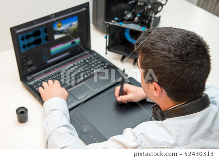 young man designer using graphics tablet for video young man designer using graphics tablet for video 52430313