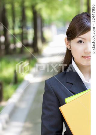 Smiling businesswoman with files 52447986