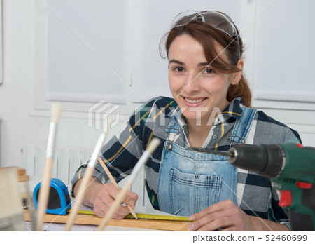 Woman doing DIY work at home Woman doing DIY work at home 52460699