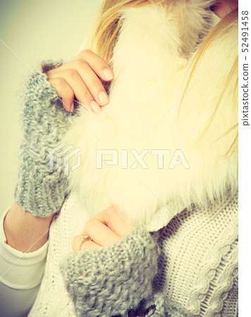 Woman wearing warm winter clothing 52491458