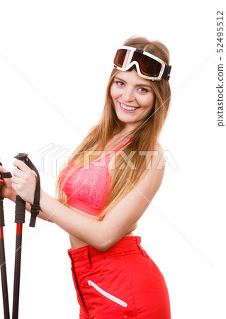 Woman wearing ski suit holding poles 52495512