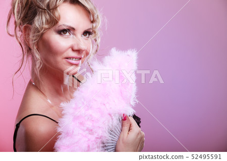 Woman holding carnival feather fan in hand. 52495591