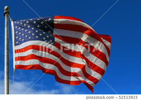 Slight Motion blur American flag against a blue Slight Motion blur American flag against a blue 52513915