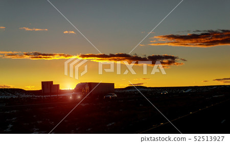 Truck cars on a highway at sunrise with beautiful Truck cars on a highway at sunrise with beautiful 52513927