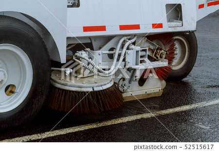 A street sweeper machine cleaning in the road A street sweeper machine cleaning in the road 52515617