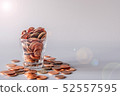 Glass of full gold coins on gray background 52557595