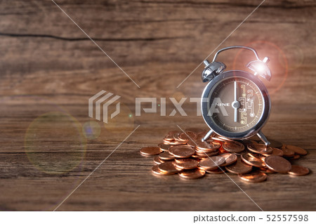 Alarm clock at six o' clock on pill of gold coins Alarm clock at six o' clock on pill of gold coins 52557598