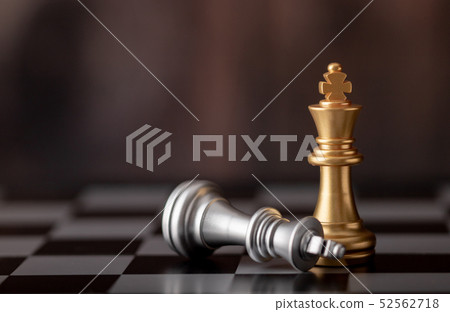 gold king standing and silver falling on chess 52562718
