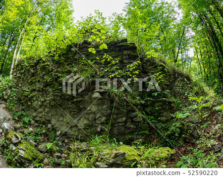 The ruins of an ancient stone fortress 52590220