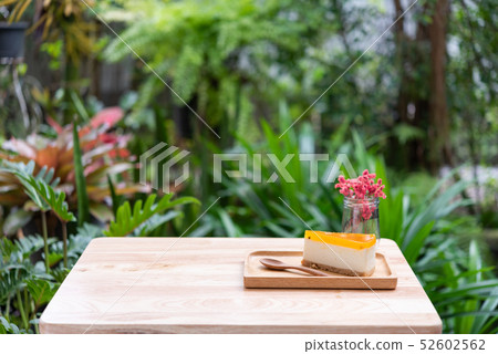 Passion fruit cheesecake serve on wood tay and 52602562