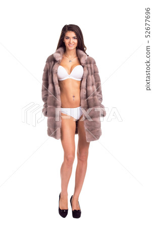 Full length portrait of beautiful brunette women in short mink coat. Full length portrait of beautiful brunette women in short mink coat. 52677696