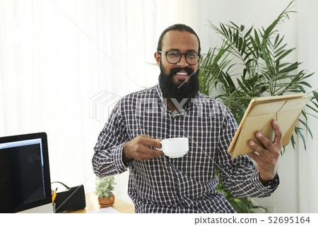 Casual businessman with tablet pc at office Casual businessman with tablet pc at office 52695164