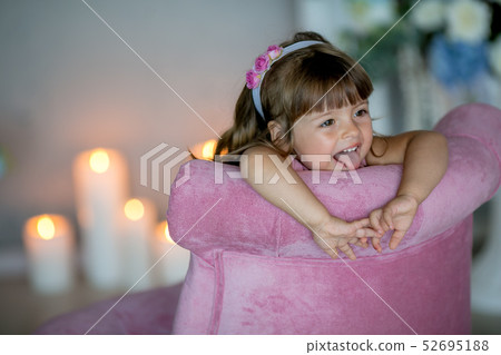 young beautiful girl ballerina in a white pink dress is standing in a white room near a white table young beautiful girl ballerina in a white pink dress is standing in a white room near a white table 52695188