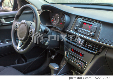 Dark luxury car Interior - steering wheel, shift lever and dashboard Dark luxury car Interior - steering wheel, shift lever and dashboard 52712038