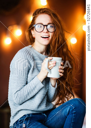 Young and sexy woman on the bed in cosy room with lot of light bulbs on background 52726841