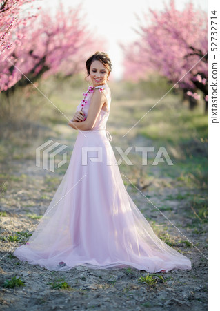 Young beautiful bride in the flowered garden. Young beautiful bride in the flowered garden. 52732714