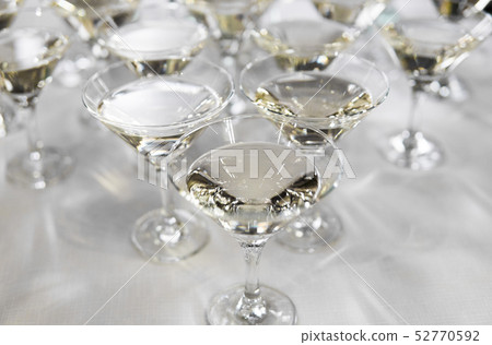Alcohol cocktails, martini, vodka and others on decorated catering bouquet table on open air event 52770592