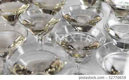 Alcohol cocktails, martini, vodka and others on decorated catering bouquet table on open air event 52770659