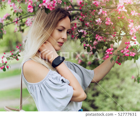 Portrait of a beautiful girl among spring foliage 52777631