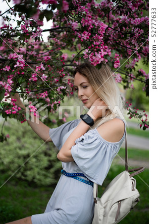 Portrait of a beautiful girl among spring foliage Portrait of a beautiful girl among spring foliage 52777633