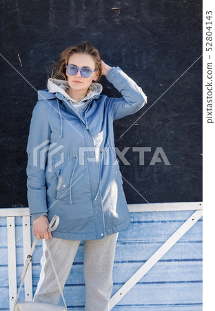 Young beautiful blonde girl walking through the city streets 52804143