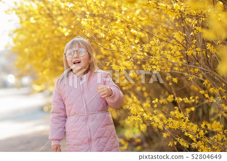 Stylish child girl 5-6 year old wearing trendy pink coat in autumn park. Looking at camera. Autumn Stylish child girl 5-6 year old wearing trendy pink coat in autumn park. Looking at camera. Autumn 52804649