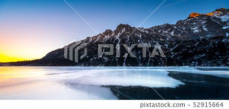 Eye of the Sea lake in Tatra mountains at sunset in a winter evening, Poland 52915664