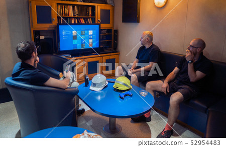 Happy team of ship officers watch TV onboard of vessel 52954483