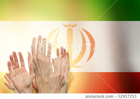People raising hands and flag Iran on background. People raising hands and flag Iran on background. 52957253