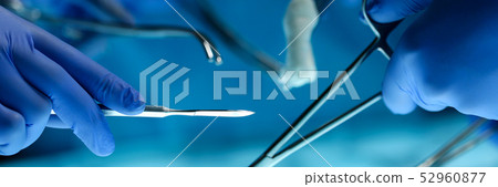 Surgeons hands holding surgical instrument 52960877