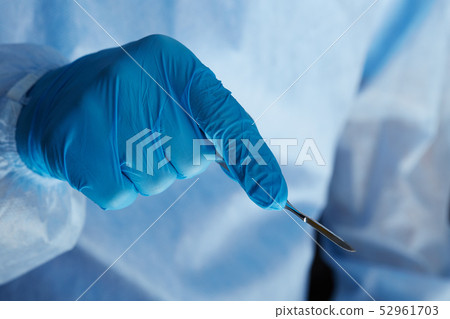 Surgeon hand holding surgical scalpel Surgeon hand holding surgical scalpel 52961703