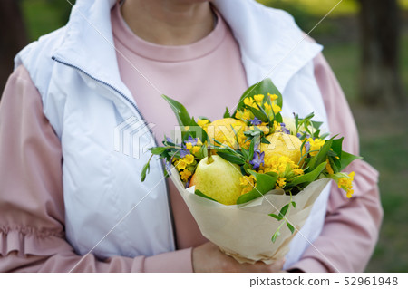 Young woman is holding a lovely bouquet Young woman is holding a lovely bouquet 52961948