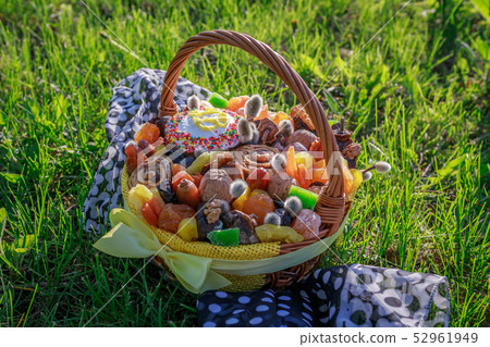 Basket with Easter cake, dried fruits and nuts Basket with Easter cake, dried fruits and nuts 52961949
