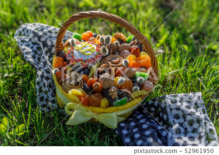 Basket with Easter cake, dried fruits and nuts Basket with Easter cake, dried fruits and nuts 52961950